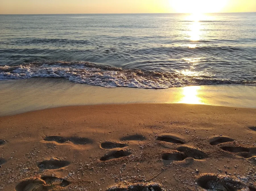 footprints in the sand at L'Auir Beach